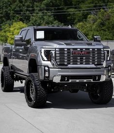 a black truck is parked in the dirt