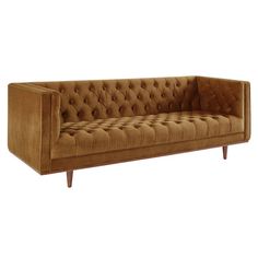 a brown couch sitting on top of a wooden table