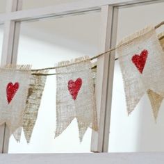 a valentine's garland hanging from a window with the words cut & crafty valentine's garland