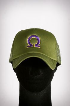 a green hat with the letter q on it's front and purple letters on the side