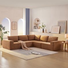 a living room filled with furniture and a rug on top of a hard wood floor