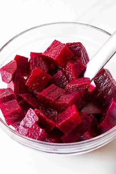 chopped beets in a glass bowl with a spoon