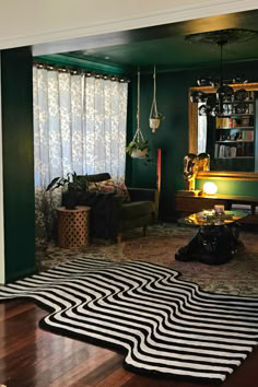 A black and gray abstract rug (lines in irregular pattern, not straight) overlaying wood floors and an oriental rug, creating a smooth transition into each room. Mid Century Maximalism, Maximalism Living Room, Elegant Eclectic, Abstract Runner Rug, Interior Design Aesthetic, Eclectic Interior Design, Blue Curtains, Modern Victorian, Living Room Rugs