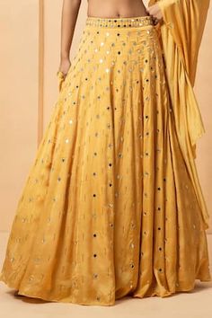 Gold attached cancan lehenga with mirror, bead, pearl embellishment. Paired with halter neck embellished padded blouse and dupatta. - Aza Fashions Eid Embellished Sleeveless Lehenga, Sleeveless Embellished Lehenga For Eid, Sleeveless Party Dress With Gota Work, Festive Anarkali Embellished Skirt, Festive Floor-length Embellished Skirt, Embellished Floor-length Festive Skirt, Yellow Embellished Choli For Eid, Designer Yellow Sequin Sets, Eid Yellow Embellished Choli