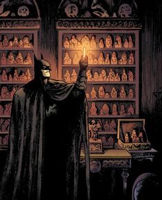 a batman standing in front of a book shelf filled with books