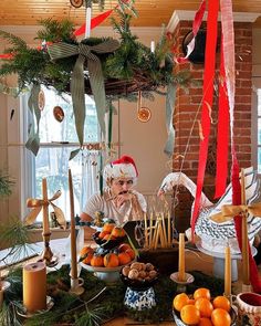 an older man sitting at a table with oranges and other foods on the table