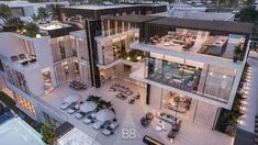 this is an aerial view of a modern house at dusk with pool and lounge area