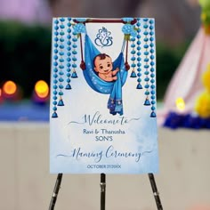 a welcome sign for a baby boy on a stand