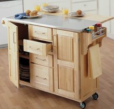 a kitchen island with drawers and plates on it