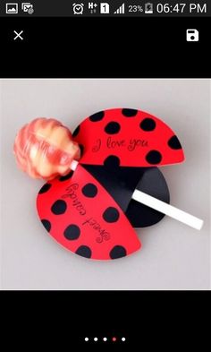 a lollipop in a heart shaped card with the words i love you on it