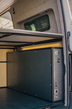 the back end of a van with its door open and storage compartment in the rear