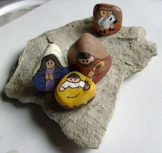 three rocks with cartoon characters on them sitting on top of a white surface next to each other