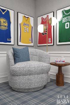 a living room with three basketball jerseys on the wall and a chair in front of it