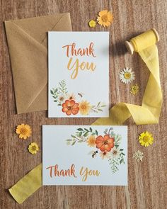 two thank you cards with flowers on them next to some yellow ribbons and paper clips