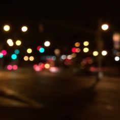 blurry image of city street at night with traffic lights