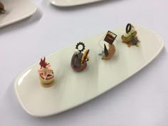 a white plate topped with miniature food items