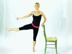 a woman standing on one leg in front of a chair