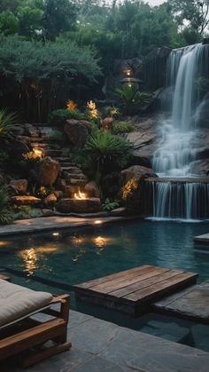 an outdoor pool with waterfall and seating area