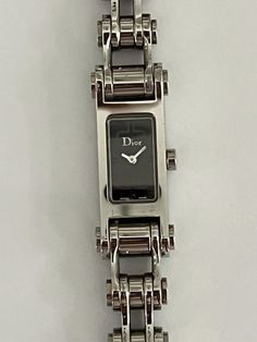 Dior Lady Watch Bracelet in steel. Model "66". Black dial. Quartz movement. Articulated "bicycle chain" bracelet. Signed DIOR, numbered. Dial: 35 x 12 mm. Length: 18cm Further information : We issue an invoice as well as a certificate of authenticity established by our qualified gemologist (LFG Paris). Our photos are not reworked and are taken in a natural light environment. We can send you a short video on request. Each jewel is delivered in a box. Each shipment is made with insurance and track Dior Watch, Bicycle Chain, Women Wrist Watch, Watch Model, Quartz Movement, Natural Light, Chain Bracelet, Womens Watches, Bracelet Watch