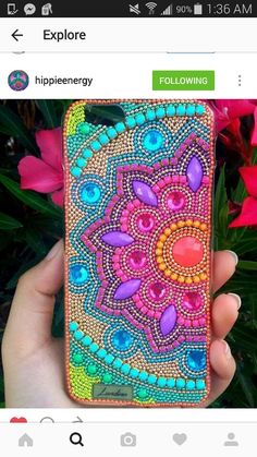 someone is holding up their phone case to show it's beaded work on the back