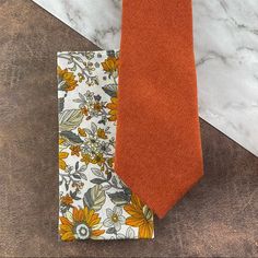 This Dapper Tie And Handkerchief Combination Is Perfect For The Groomsmen To Coordinate In Your Wedding. It’s Also A Great Style For Parties And Proms! Includes: (1) Necktie / Slim Width, Approx. (W) 2.75” X (L) 58, Cotton-Polyester Blend (Velour Micro-Twill With A Soft, Suede Texture), Dry Clean Only (1) Floral Print Pocket Square / 100% Cotton Fabric, Approx. 12” X 12”, Dry Clean Only Thank You! Grooms Suits, Floral Pocket Square, Blue Gray Gold, White Sunflower, Necktie Set, White Sunflowers, God Father, Wedding Tie, Orange Tie