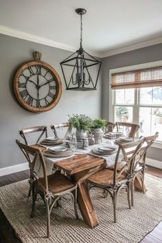 a dining room table with chairs and a clock on the wall in the back ground