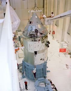 the space shuttle is being worked on in an assembly facility with workers working on it