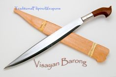 a wooden handle knife on top of a cutting board with the words visayan barong written below it