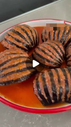 some food is sitting in a bowl on a table with an orange and white plate