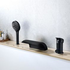 two black faucets sitting on top of a counter next to bottles and soap dispensers