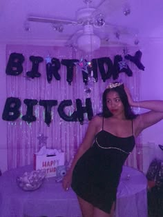 a woman standing in front of a birthday sign