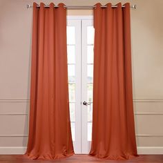 an orange curtain hanging in front of a white door