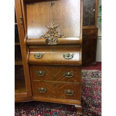 an old wooden dresser sitting on top of a rug