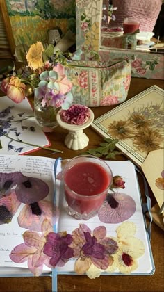 an open book on a table with flowers