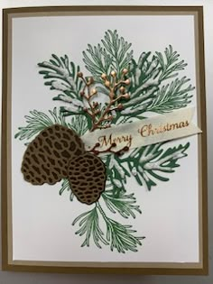 a handmade christmas card with pine cones and acorns