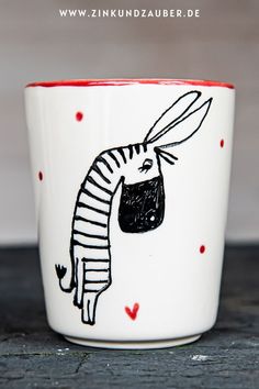 a cup with a drawing of a zebra on it