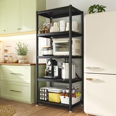 a kitchen with green cabinets and white appliances