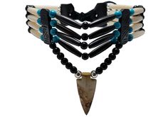 - Made from authentic buffalo bone hairpipe beads, genuine leather, 6 mm round metal beads, 6 mm synthetic round beads, and Picture Jasper stone. - 13.5 inches long (without the leather ties). - Hand carved Picture Jasper stone arrowhead pendant. - 100% Handmade by an artisan. - 4 strand traditional tribal bone choker. All of our jewelry is finely hand crafted in the united states using the finest materials available today. You can expect the best quality and craftsmanship in every piece we make Bone Choker, Arrowheads Design, Native American Crafts, Native Jewelry, Picture Jasper, Choker Necklaces, Handmade Beads, Mens Accessories Fashion, American Jewelry