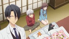 three anime characters sitting on the floor in front of a bed with an unmade sheet