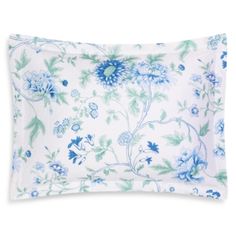 a blue and white pillow with flowers on it