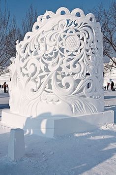 a large white sculpture sitting in the snow