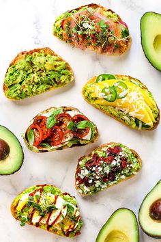 avocado toast with different toppings arranged on a marble surface