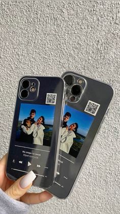 someone is holding up two cell phones with pictures on the front and back of them