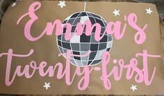 a cardboard sign with the words emma's twenty - first written on it