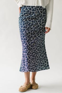 Discover playful sophistication with the Boyden Floral Midi Skirt. This navy skirt features a charming floral print, perfect for making a statement. Its midi length offers versatility for any occasion. Add a touch of whimsy to your wardrobe with this fun and stylish piece. Details self/lining: 65% cotton + 35% rayon Fabric Care Guide Here Sizing & Fit Measurements are approximate and taken while laying flat across the front. Not doubled. x-small: waist = 13"; length = 32" small: waist = 14"; len Piper And Scoot, Winter Maternity, Maxi Dress Pattern, Navy Skirt, Ruffle Sleeve Blouse, Floral Midi Skirt, Rayon Fabric, Small Waist, Dress Details