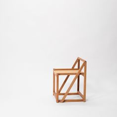 a wooden chair sitting on top of a white floor