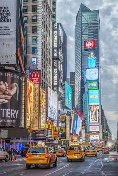 a busy city street filled with lots of traffic and tall buildings covered in neon signs