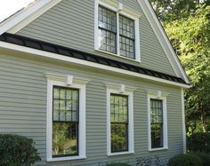 a gray house with white trim and windows