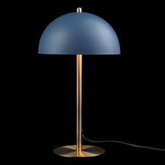 a blue lamp with a gold base on a black background and a cord running through it