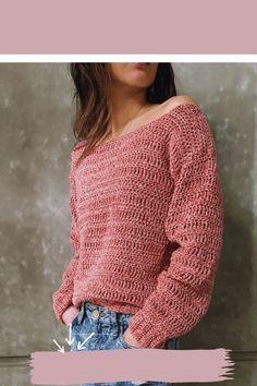 a woman standing in front of a wall wearing a pink sweater and denim shorts with her hands in her pockets